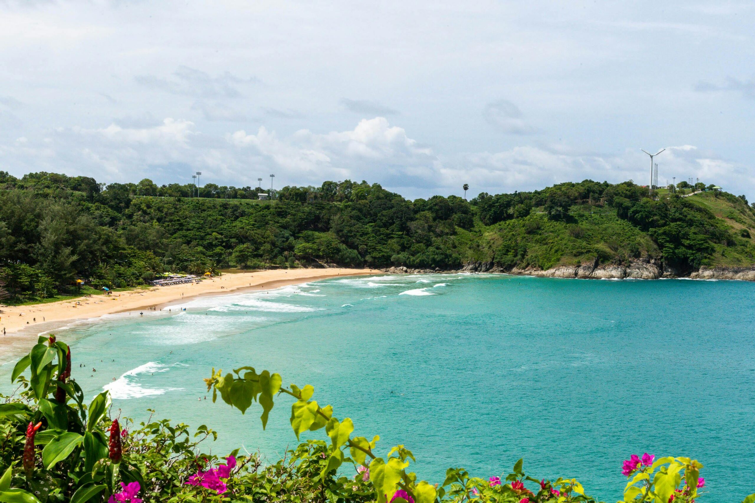 Breathtaking view of a tropical beach surrounded by vibrant greenery in Thailand.